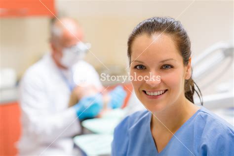 Female Dental Assistant Smiling At Stomatology Office Dentist With Patient Royalty Free Stock