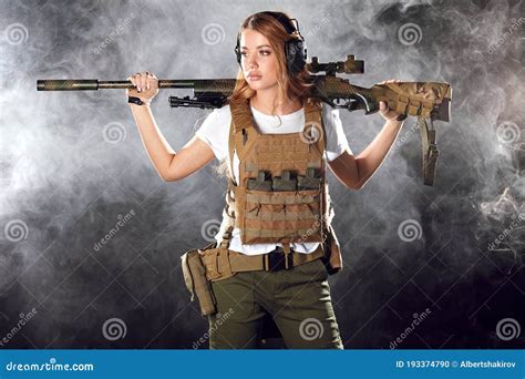 Cute Sniper Woman With Rifle In Hands Standing In Military Outfit In