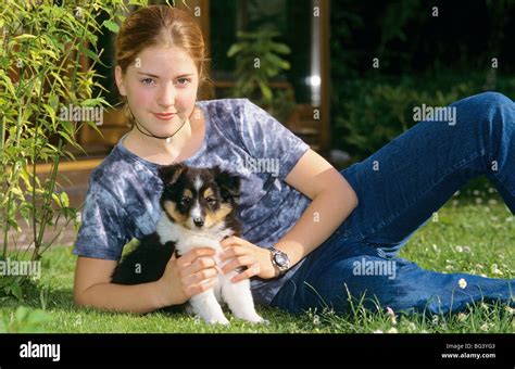 Girl With A Border Collie Dog Puppy On Meadow Stock Photo Alamy
