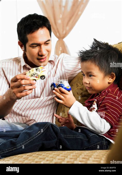 Son And Father Holding Car Models Stock Photo Alamy