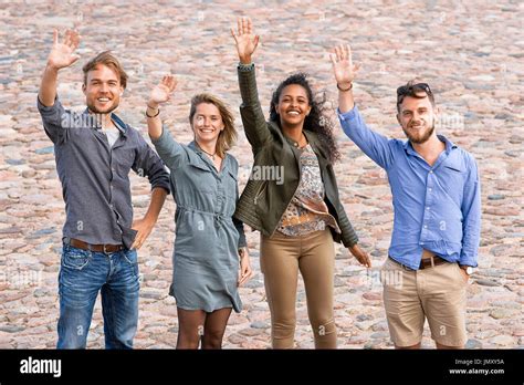 Group Of Young Friends Waving Their Hands As A Gesture Of Saying Stock