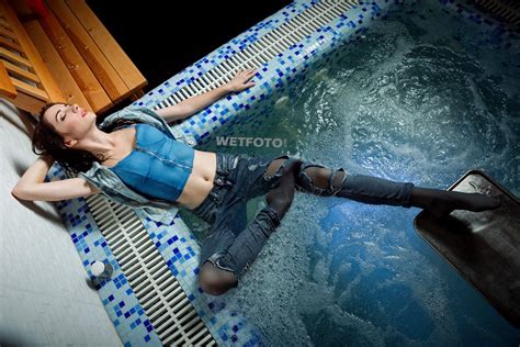 relaxation by super brunette girl in ripped jeans and gray tights in jacuzzi