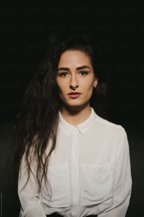 Pretty Woman In White Button Up Shirt Septum Piercing And Long Dark Hair By Stocksy
