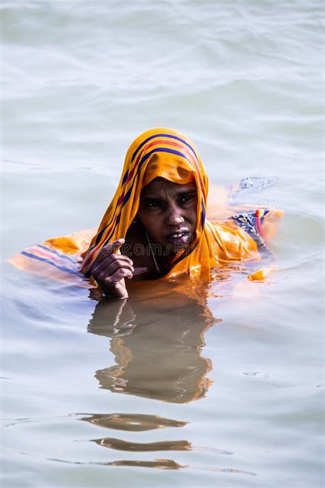 Varanasi India 16 November 2019 Life On The Ganges Woman In A Bright Yellow Or Orange Sari