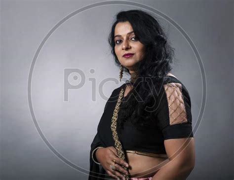 Image Of Middle Aged Indian Woman Wearing Traditional Designer Wear