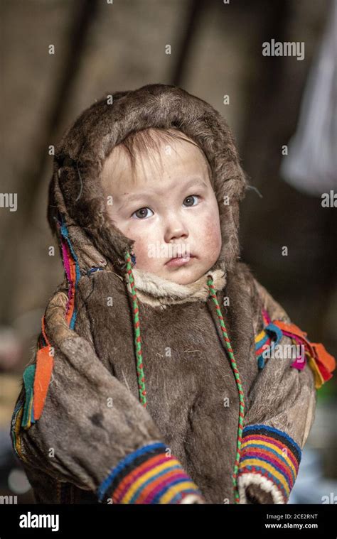 Portrait Of A 2 Years Old Nenet Child With Traditional Wear Inside A