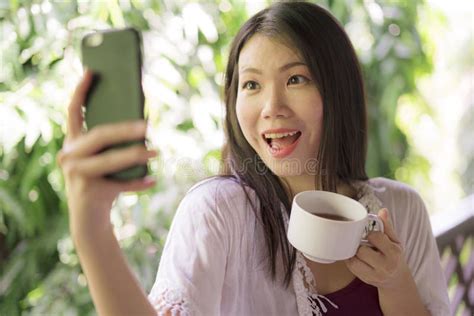 Young Beautiful And Happy Asian Chinese Woman Having Morning Coffee