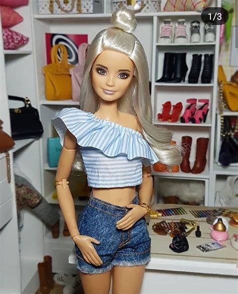 a barbie doll is standing in front of a closet full of shoes and purses