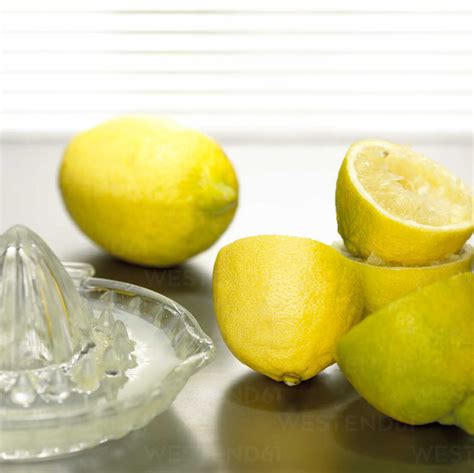 Lemons With Lemon Squeezer Close Up Stock Photo