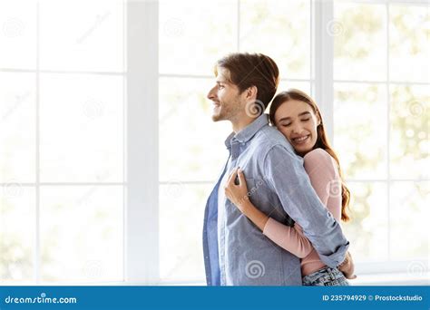 Smiling Millennial European Man Look Outside Woman Hugs Her Husband