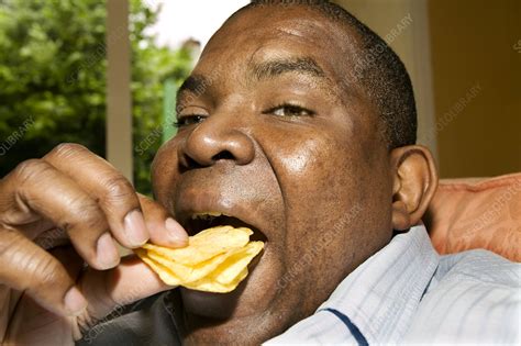 Man Eating Crisps Stock Image P9200567 Science Photo Library