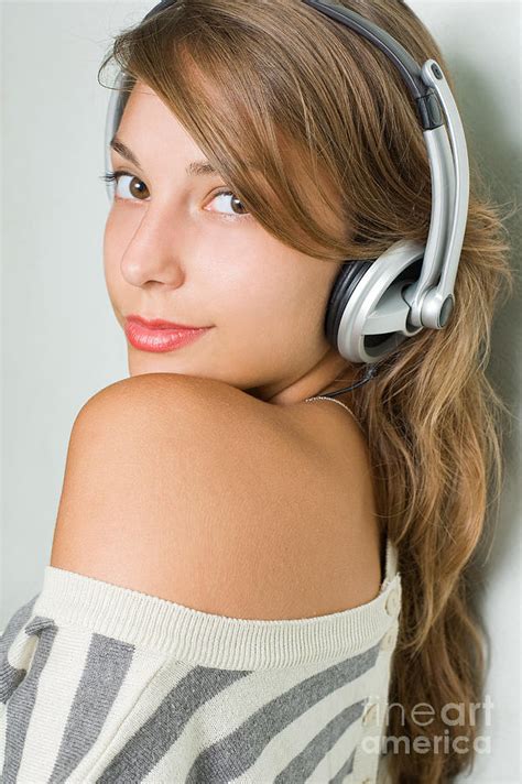Beautiful Young Brunette Listening To Music With Headphones Photograph