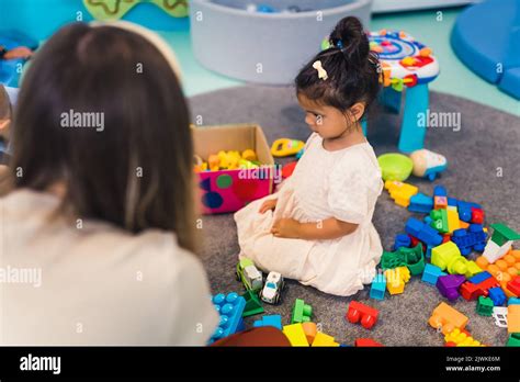 Learning through play at the nursery school. Toddler little girl and