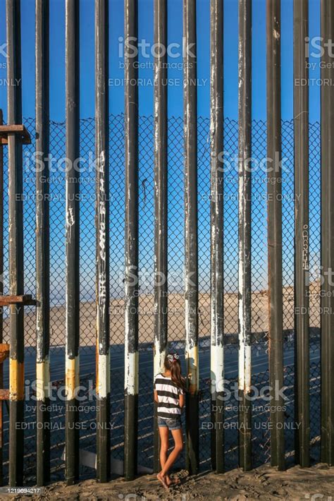 A Girl Looks Through The Steel Wall On The Usmexico Border In Tijuana