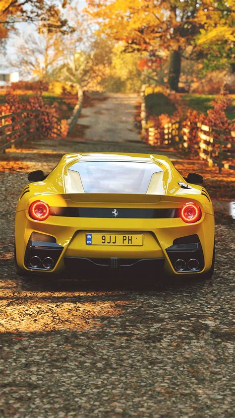 This small yellow car is photographed parked in front of a run down wall. Download wallpaper 2160x3840 ferrari, sports car, yellow ...