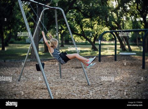 Side View Of Girl Swinging At Park Stock Photo Alamy
