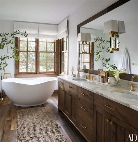 A Bathroom With A Large White Bathtub Sitting Next To A Sink And Two