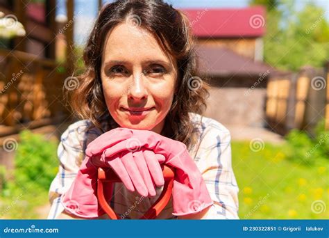 A Woman Is Gardening In Her Backyard She Plants Seedlings Stock Image