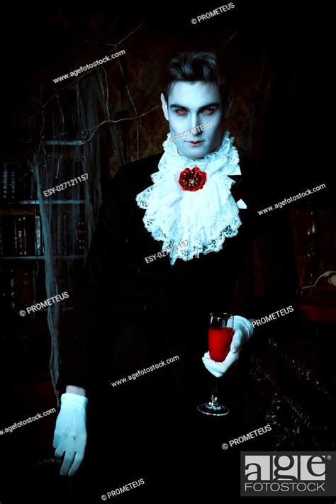 Handsome Vampire Man Wearing Elegant Tailcoat Stands In The Old