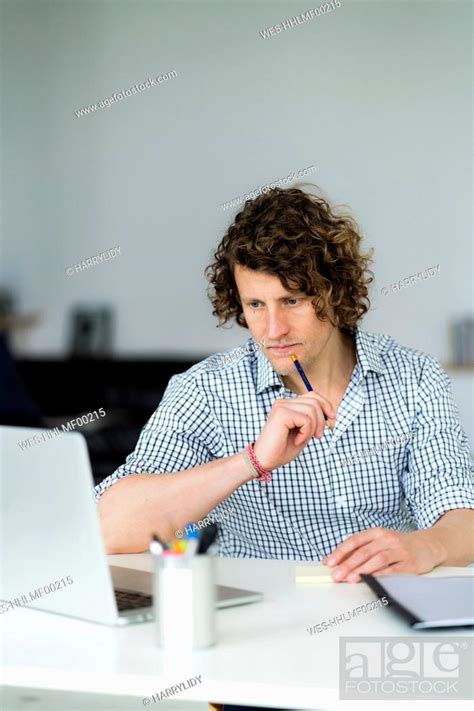 Businessman Taking Notes With A Pencil Stock Photo Picture And
