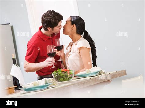 Couple Kissing In Kitchen Stock Photo Alamy
