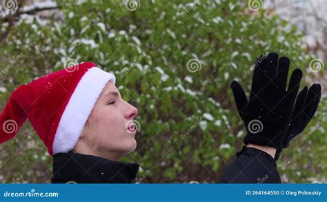 A Teenager In A Santa Hat Smiles And Laughs Against The Backdrop Of