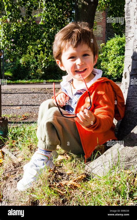 Caucasian Child Boy 3 4 Year Old Sitting Outdoors With Back Against