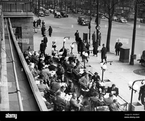Guests Sit On The Terrace Of Cafe Kranzler On The Kurfuerstendamm In Berlin On The Right
