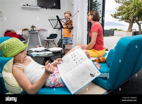 Two Girls Doing Their Homework One Playing The Violin Kaikoura South