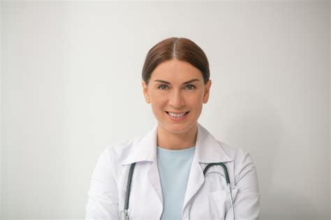 premium photo a picture of dark haired female doctor in a white robe