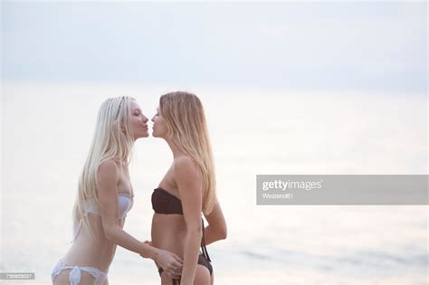 Two Young Women Kissing At The Sea Photo Getty Images