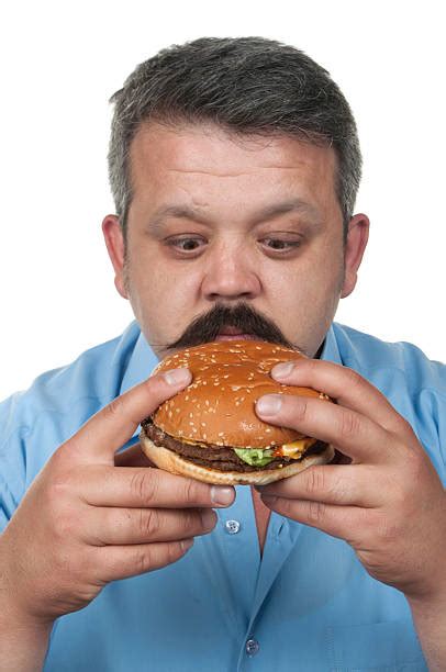 Fat Man Eating Cheeseburger With Enjoyment Stock Photos Pictures