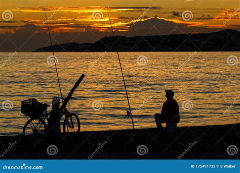 Man Fishing On The Coast At Sunset Silhouette Stock Photo Image Of