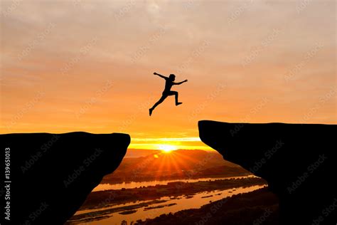 Courage Man Jumping Over Cliff On Sunset Backgroundbusiness Concept Idea Stock Foto Adobe Stock