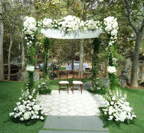 Gorgeous Chuppah Wedding Arch Adorned With All White Flowers White