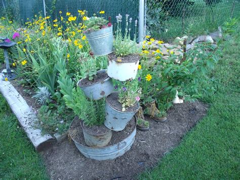 My Old Pails And Bucketsstacked Using Rebar To Make Tipsy Pots I Had