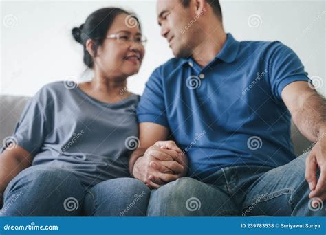 Portrait Of Asian Mature Couple Sitting In The Living Room Wife And