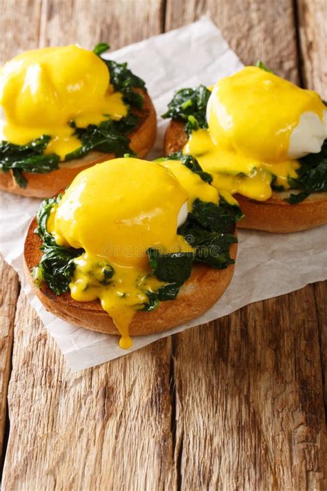 Breakfast Of Poached Eggs With Spinach And Hollandaise Sauce On Bread