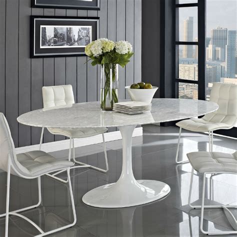 The table 'chained up miami' is an important dining table with structure in mirror polished stainless steel and top in calacatta marble, origin: Top 5 Gorgeous White Marble Round Dining Tables