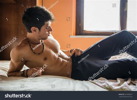 shirtless sexy male model lying alone foto stock 323390507 shutterstock