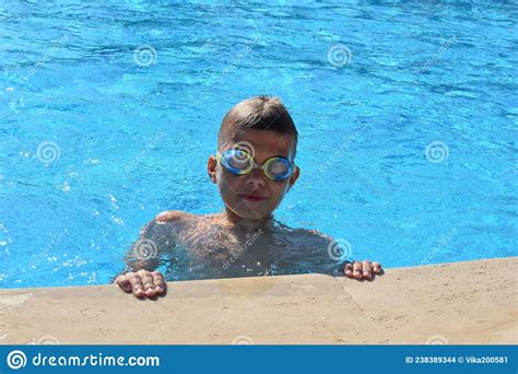 Cheerful Happy Boy Child Swim In Swimming Pool In Summer Outside