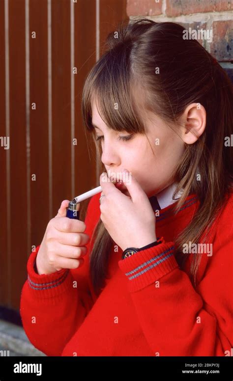 Schoolgirl In Uniform Lighting A Cigarette Cigaret Stock Photo Alamy