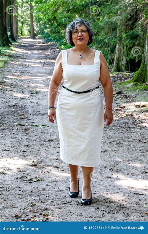Beautiful Mature Mexican Woman In A White Dress Walking Towards The