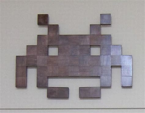 A Metal Wall Sculpture With Squares And Rectangles On Its Side