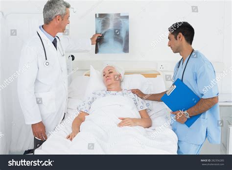 Male Doctors Examining Xray Patient Hospital Stock Photo 282356285