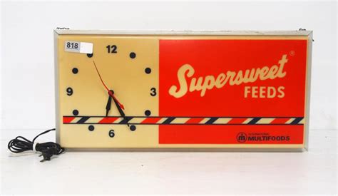 Sold At Auction Lighted Supersweet Feeds Sign With Clock
