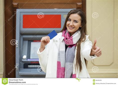 Young Happy Brunette Woman Withdrawing Money From Credit Card At Stock
