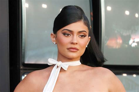 kylie jenner wears an 87 catsuit from asos with pvc sandals footwear news