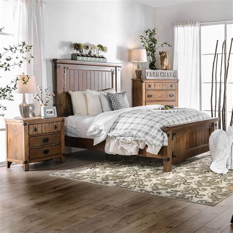 Country style primary bedroom featuring orange walls and hardwood flooring topped by an area rug, along with a tall white ceiling. Shop Furniture of America Sierren Country Style 3-piece ...