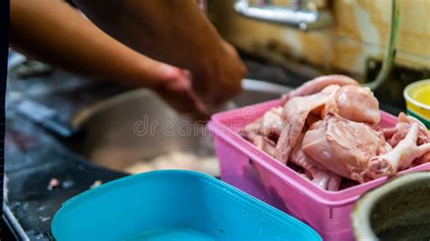 Male Hand Cleaning And Washing The Chicken Meat With Tap Water At The